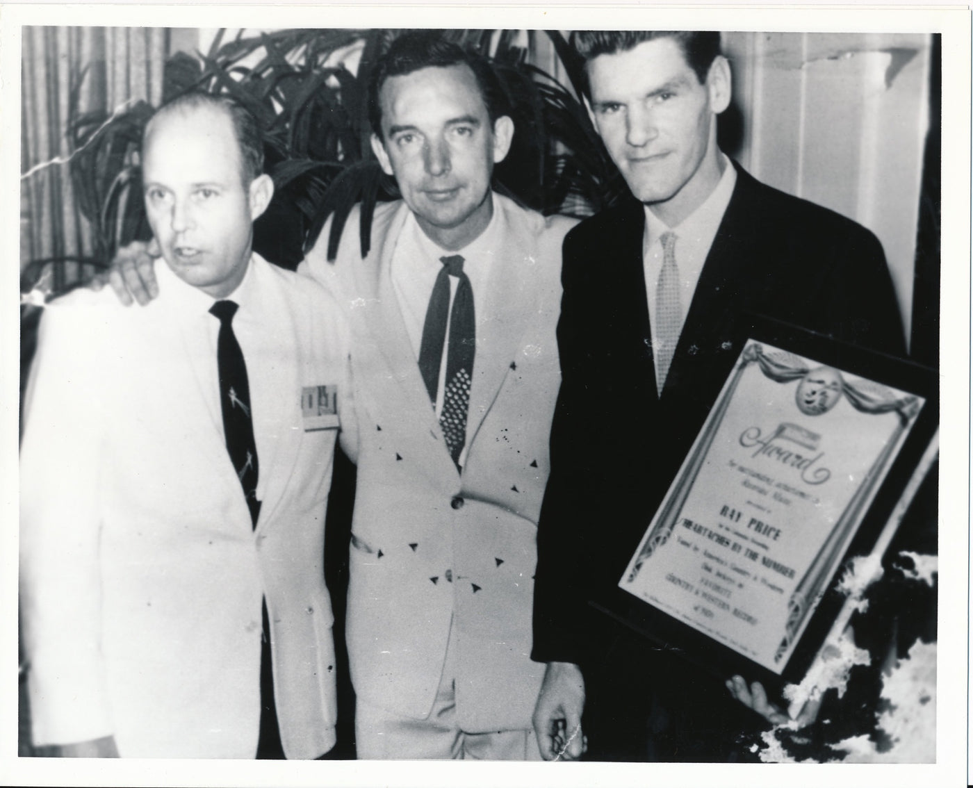 A young Ray Price and Harlan Howard receiving a BMI award for Heartaches by the Number