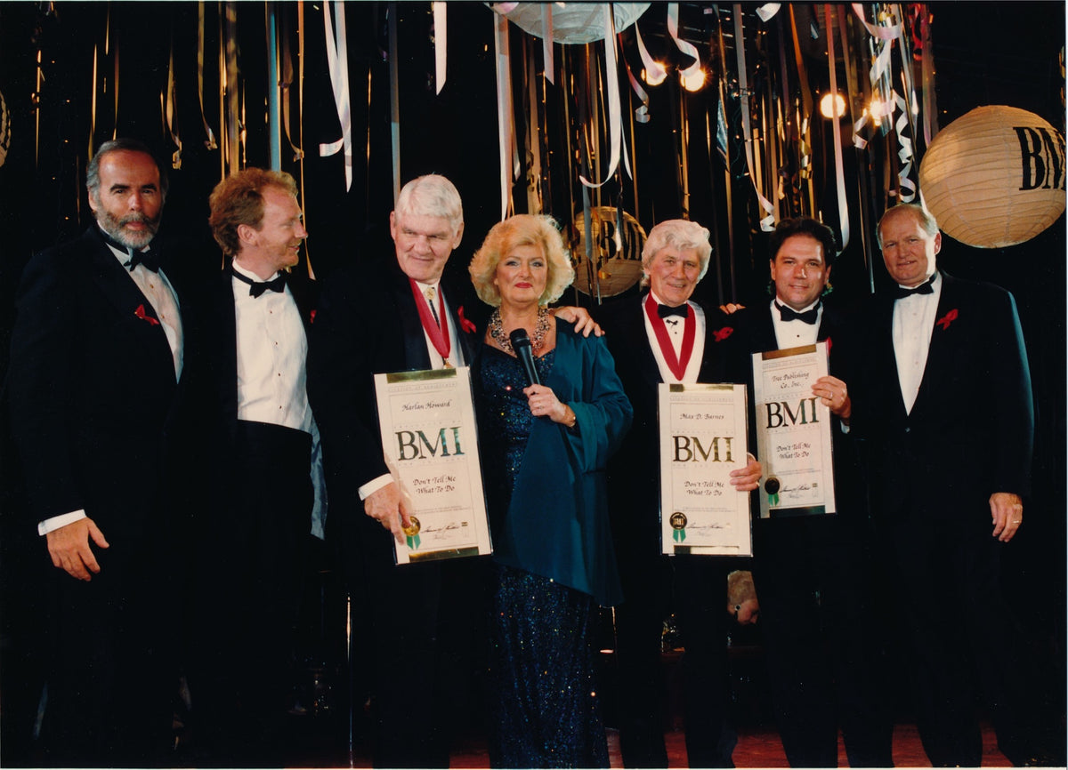 Harlan Howard and Max D. Barnes receiving a BMI award for Don't Tell Me What To Do, with producer Paul Worley, Frances Preston, Walter Campbell and Roger Sovine